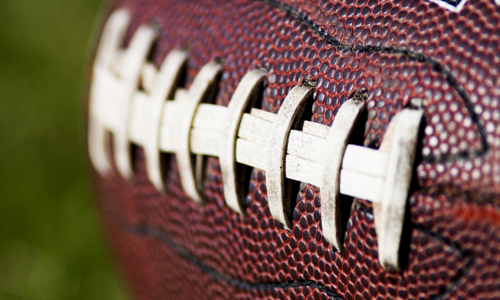 Close,Up,Of,An,American,Football,Against,A,Black,Background